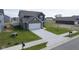 A two-story home displays a large driveway, lush green grass, and an attached two-car garage at 1181 Galaxy Ln, Danville, IN 46122