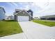 This new two-story home boasts an attached garage, a large driveway, and a freshly sodded lawn at 1181 Galaxy Ln, Danville, IN 46122