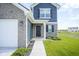 Inviting two-story home with brick and siding, featuring a charming front door and well-maintained landscaping at 1181 Galaxy Ln, Danville, IN 46122