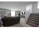 Cozy living room features a staircase, comfortable seating, and decorative fireplace at 1181 Galaxy Ln, Danville, IN 46122