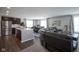 Open-concept living space with stainless steel appliances, island, and comfortable leather seating at 1181 Galaxy Ln, Danville, IN 46122