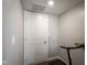 A compact room displays a white door, light-grey walls, and a section of a treadmill at 1181 Galaxy Ln, Danville, IN 46122