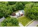 An aerial view features the modern home, manicured lawn, and mature trees on the property at 11911 Eden Glen Dr, Carmel, IN 46033