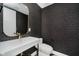 Elegant half-bathroom featuring modern finishes, stylish wallpaper, and a gold-framed mirror at 11911 Eden Glen Dr, Carmel, IN 46033