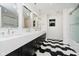 Modern bathroom featuring a spacious vanity, sleek fixtures, and stylish black and white flooring at 11911 Eden Glen Dr, Carmel, IN 46033
