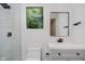 Bathroom with subway tile shower, modern fixtures, and window with a view at 11911 Eden Glen Dr, Carmel, IN 46033