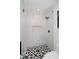 Bathroom shower featuring decorative tile, black hardware, and window at 11911 Eden Glen Dr, Carmel, IN 46033