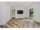 Bright bedroom features herringbone floors, recessed lighting, a window, and an open door at 11911 Eden Glen Dr, Carmel, IN 46033