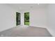 Bright bedroom with neutral carpet and two large windows overlooking the trees at 11911 Eden Glen Dr, Carmel, IN 46033