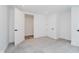 Bright bedroom featuring neutral carpet, minimalist design, and closet at 11911 Eden Glen Dr, Carmel, IN 46033