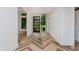 Light-filled foyer with stylish herringbone flooring and a modern glass-paneled front door at 11911 Eden Glen Dr, Carmel, IN 46033