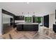 Modern kitchen boasts an island with a cooktop, stainless steel appliances, and herringbone hardwood floors at 11911 Eden Glen Dr, Carmel, IN 46033