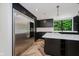 Bright and modern kitchen featuring stainless steel appliances and herringbone hardwood floors at 11911 Eden Glen Dr, Carmel, IN 46033