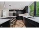 Spacious kitchen with stainless steel appliances, quartz countertops, and views to the backyard at 11911 Eden Glen Dr, Carmel, IN 46033