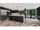 Modern kitchen featuring a large island, stainless steel appliances, and access to the pool at 11911 Eden Glen Dr, Carmel, IN 46033