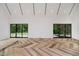Open concept living room featuring herringbone floors and a glass sliding door to the backyard at 11911 Eden Glen Dr, Carmel, IN 46033
