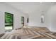 Bright living room with herringbone wood floors and modern pendant lighting near the black frame windows at 11911 Eden Glen Dr, Carmel, IN 46033