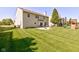 Expansive backyard featuring a patio, fire pit, manicured lawn, and a play structure at 1238 Aggie Ln, Indianapolis, IN 46260