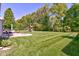 Expansive backyard featuring a well maintained lawn, patio area and mature trees at 1238 Aggie Ln, Indianapolis, IN 46260