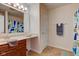 Bathroom featuring a vanity, large mirror and shower-tub combination with a patterned curtain at 1238 Aggie Ln, Indianapolis, IN 46260