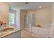 Bathroom features a soaking tub, walk-in shower, and double sinks with granite countertops at 1238 Aggie Ln, Indianapolis, IN 46260
