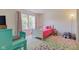 Bright bedroom with a fun pink bed, colorful rug, and a whimsical teddy bear at 1238 Aggie Ln, Indianapolis, IN 46260