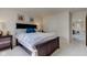 Cozy bedroom with large bed, side table, and doorway to hall with colorful décor at 1238 Aggie Ln, Indianapolis, IN 46260