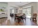 Bright dining room with patio door leading to a backyard with play set and hardwood floors at 1238 Aggie Ln, Indianapolis, IN 46260