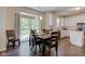 Dining area boasts sliding glass doors, hardwood floors, stylish lighting and kitchen access at 1238 Aggie Ln, Indianapolis, IN 46260