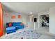 A cheerful living room with bright blue couch and colorful rug that is perfect for entertaining at 1238 Aggie Ln, Indianapolis, IN 46260