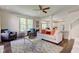 Cozy living room featuring a ceiling fan, a stylish rug, and an open layout that connects to the kitchen at 1238 Aggie Ln, Indianapolis, IN 46260