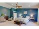 Spacious main bedroom with blue accent wall, sitting area, TV and ensuite bathroom at 1238 Aggie Ln, Indianapolis, IN 46260