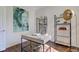 Contemporary home office with wood floors, desk and modern shelving, highlighted by buddha artwork at 1238 Aggie Ln, Indianapolis, IN 46260