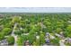 Overhead shot of a quiet, residential neighborhood with tree-lined streets and well-maintained homes on a partly cloudy day at 1245 Kessler Blvd E Dr, Indianapolis, IN 46220