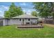 Grassy backyard with a charming deck and outdoor seating perfect for gatherings and relaxation at 1245 Kessler Blvd E Dr, Indianapolis, IN 46220