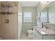 Bathroom with granite counters, beautiful tilework, and a shower with built in shelving for toiletries at 1245 Kessler Blvd E Dr, Indianapolis, IN 46220