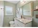 Charming bathroom with granite counters, picture frame mirror, and natural light from the window at 1245 Kessler Blvd E Dr, Indianapolis, IN 46220