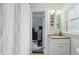 Bathroom with a white cabinet, granite counters and view into a bedroom with exercise equipment at 1245 Kessler Blvd E Dr, Indianapolis, IN 46220