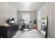 Bedroom with workout area, stationary bike, dresser, and hardwood floors with a patterned rug at 1245 Kessler Blvd E Dr, Indianapolis, IN 46220