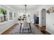 Dining room with wood floors, modern table and chairs, and view into the updated kitchen at 1245 Kessler Blvd E Dr, Indianapolis, IN 46220