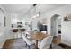 Dining area featuring a pendant light fixture over a wooden table and seating for four at 1245 Kessler Blvd E Dr, Indianapolis, IN 46220