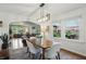 Bright dining room features modern lighting, hardwood floors, with views into living room and outside the large picture windows at 1245 Kessler Blvd E Dr, Indianapolis, IN 46220
