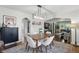 Dining area with modern lighting that leads into a bright living room and a view of the kitchen at 1245 Kessler Blvd E Dr, Indianapolis, IN 46220