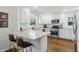 Bright and airy kitchen with white cabinets, stainless appliances, granite countertops, and hardwood floors at 1245 Kessler Blvd E Dr, Indianapolis, IN 46220