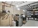 Basement laundry room with updated machines, storage, and good lighting, combining functionality with practicality at 1245 Kessler Blvd E Dr, Indianapolis, IN 46220