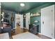 Living room with hardwood floors, dark teal walls, and views into adjoining rooms through open doors at 1245 Kessler Blvd E Dr, Indianapolis, IN 46220
