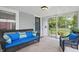 Relaxing screened porch area with wicker furniture, blue cushions, and views of the surrounding neighborhood at 1245 Kessler Blvd E Dr, Indianapolis, IN 46220