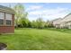 Expansive backyard featuring lush green grass and secure black fencing, perfect for outdoor activities and privacy at 13234 Amundson Dr, Carmel, IN 46074