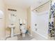 Bright bathroom featuring a shower-tub combo, pedestal sink, neutral color scheme and tile flooring at 13234 Amundson Dr, Carmel, IN 46074