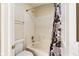 Bright bathroom featuring a shower-tub combination with patterned curtain, toilet, and towel bar at 13234 Amundson Dr, Carmel, IN 46074